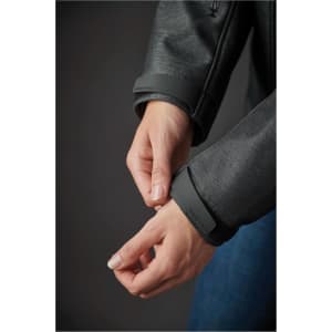 A close-up of hands adjusting the cuffs of a grey Women's Epsilon System Jacket. The jacket features a logo on the cuff.