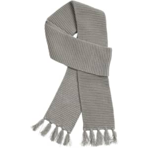 A soft, light grey knit scarf with a textured pattern and fringed ends. It features a logo.