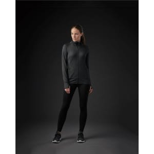 A women's Pacifica jacket in black, featuring a zip front and a modern fit, paired with black leggings and shoes.