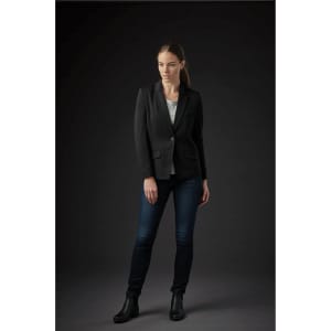 A women's black knit blazer with a single button, worn over a light top and paired with dark jeans and ankle boots.