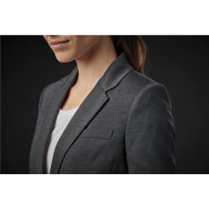 A grey women's blazer with a notch lapel and a single chest pocket, displayed on a model against a dark background.
