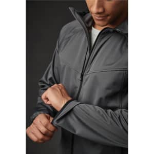A grey softshell jacket with a high collar and zipped front, being worn by a person adjusting the sleeve.