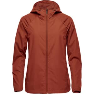 A women's wind jacket in a rust orange colour, featuring a hood and a zip closure, with a logo on it.