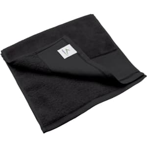 A black fitness towel, featuring a folded corner and a small branded label on its edge.