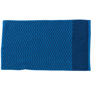 A blue gym towel with a patterned design and a pocket on one side. It features a logo.