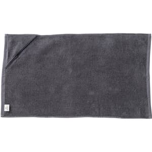 A dark grey gym towel with a pocket, made of soft material, featuring a small logo on one corner.