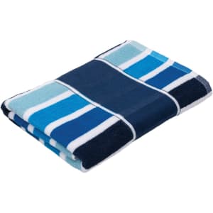 A folded Cabana Towel featuring blue and turquoise stripes, with a logo on the fabric.