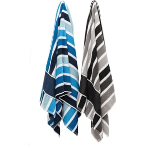 Two striped cabana towels hanging, one in shades of blue and the other in grey and black. Both feature a logo.