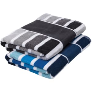 Two folded cabana towels featuring grey, black, navy, and aqua stripes, with a band around each set.