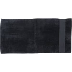 A dark black beach towel featuring a simple design, ideal for leisure and outdoor use. It has a logo on one side.