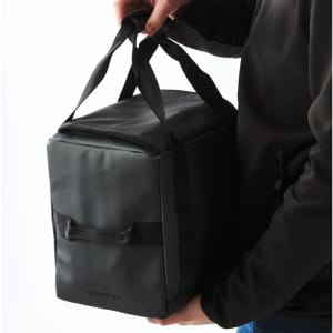 A black Tundra 24 Can Cooler Pack, featuring sturdy handles for carrying. Includes a logo on the side.