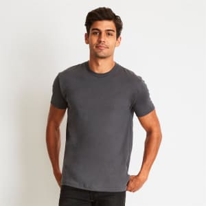A men's grey cotton crew t-shirt is worn by a model, featuring a classic crew neck and short sleeves.