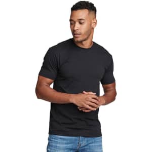 A man wearing a black men's CVC crew t-shirt, standing casually with hands clasped, featuring a logo on the shirt.