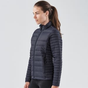 A navy women's jacket featuring a zip-up front and a fitted design, with a subtle branding logo.