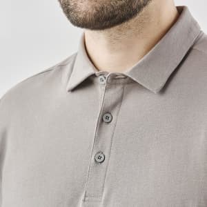 A men's long-sleeve polo shirt in a muted grey shade featuring a collar and button details. It includes a logo on the chest.