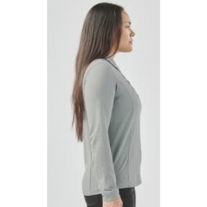 A women's long-sleeve polo shirt in grey, featuring a collar and a fitted design, with a visible logo.