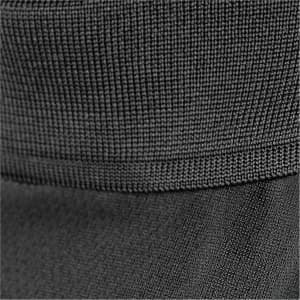 A close-up of a black polo shirt featuring textured fabric and a subtle hem detail.