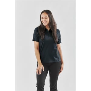 A black women's polo shirt displayed on a model, featuring a collar and short sleeves. The design includes a logo.