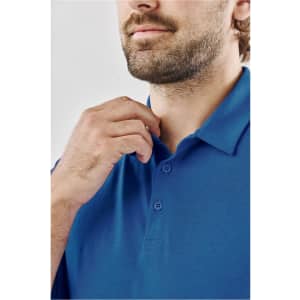 A close-up of a man adjusting a blue polo shirt with a three-button placket and a collar, featuring a logo.