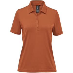 A women's polo shirt in a warm rust colour, featuring a classic collar and three-button placket. It has a logo.