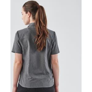 A women's quick dry button-up shirt in grey, featuring short sleeves and a collar. The shirt has a logo on it.
