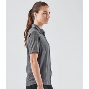 A women's short-sleeve button-up shirt in grey, featuring a sleek design and a logo on the fabric.