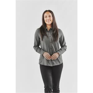 A button-up shirt in dark grey worn by a smiling woman, featuring a logo on the design.