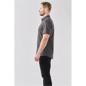 A grey button-up shirt with short sleeves, featuring a subtle pattern, displayed on a model from the side.
