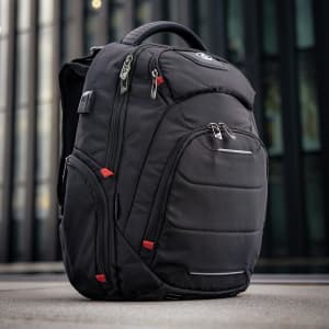 A black Swissdigital Neptune Backpack featuring multiple pockets and zippers, with accents in red and a logo.