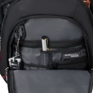 An inner pocket of a black backpack featuring compartments for a pen, keys, and a small device.