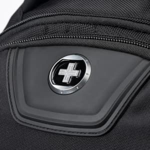 A close-up of a black backpack featuring a logo and a zipped pocket. The material appears durable and textured.