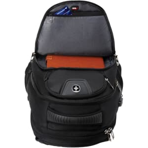 A black backpack with a spacious interior, showing an orange notebook and a pocket for storage. It features a logo.