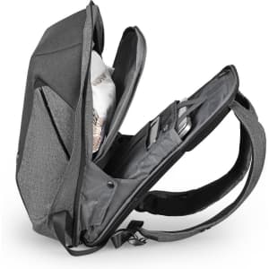 A grey backpack with a spacious interior, featuring multiple compartments and a branding logo.