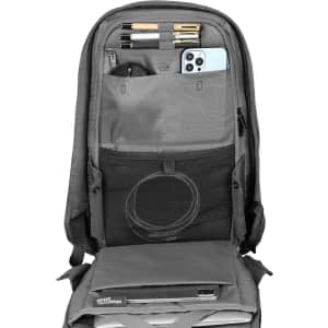 A grey backpack interior with compartments for pens, a phone, cables, and a laptop. It includes a logo.