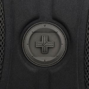 A close-up of a black backpack featuring a round logo with a minimalist design.