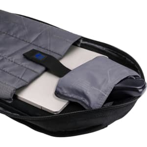 A grey Swissdigital Terabyte Backpack with a padded compartment holding a laptop and a small accessory pouch.