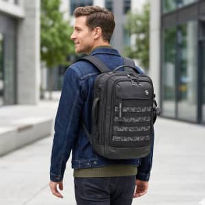A man wearing a denim jacket carries a black Swissdigital Berg L Backpack with a patterned front in an urban setting.