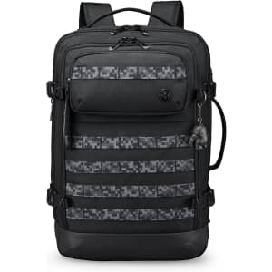 A black backpack with a patterned front panel and multiple pockets. It features adjustable straps and a logo.