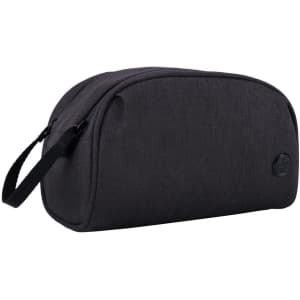 A dark grey toiletry bag with a sleek design and side handle, featuring a logo on the front.