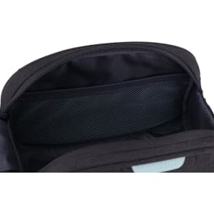 A black toiletry bag with a zippered opening, featuring a mesh pocket inside for organisation.