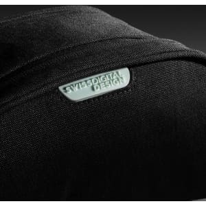 A black toiletry bag with a textured surface and a logo. The design is sleek and modern.