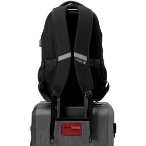 A black Swissdigital Vector Backpack with padded straps, positioned on top of a suitcase, featuring a logo.