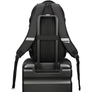 A black backpack displayed on top of a suitcase, featuring adjustable straps and a structured design.