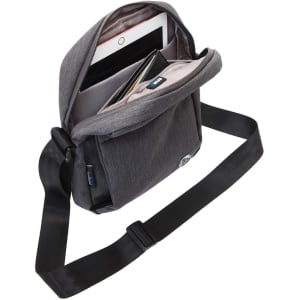 A grey shoulder bag with an open flap, featuring compartments for a tablet and accessories. It has a logo.