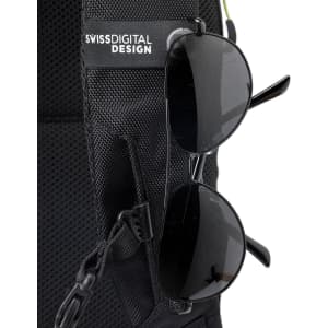 A black backpack featuring a front pocket with sunglasses attached, displaying a logo on the strap.