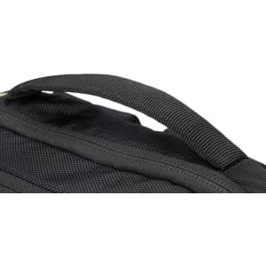 A close-up of a black backpack featuring a sturdy handle and textured fabric. It has a logo visible on it.