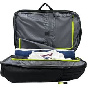 A black Swissdigital Java Backpack with yellow accents, featuring an open compartment revealing a towel and a folded shirt.