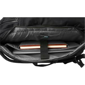 A black backpack interior featuring a laptop compartment, a notebook, and grey lining. It has a logo visible inside.