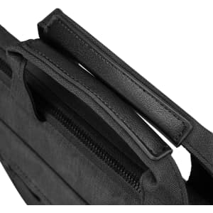 A black laptop sleeve with a textured surface and dual handles sits against a white background.