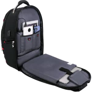 A black backpack with multiple compartments, featuring grey interior padding and a logo. It holds devices like a laptop and tablet.